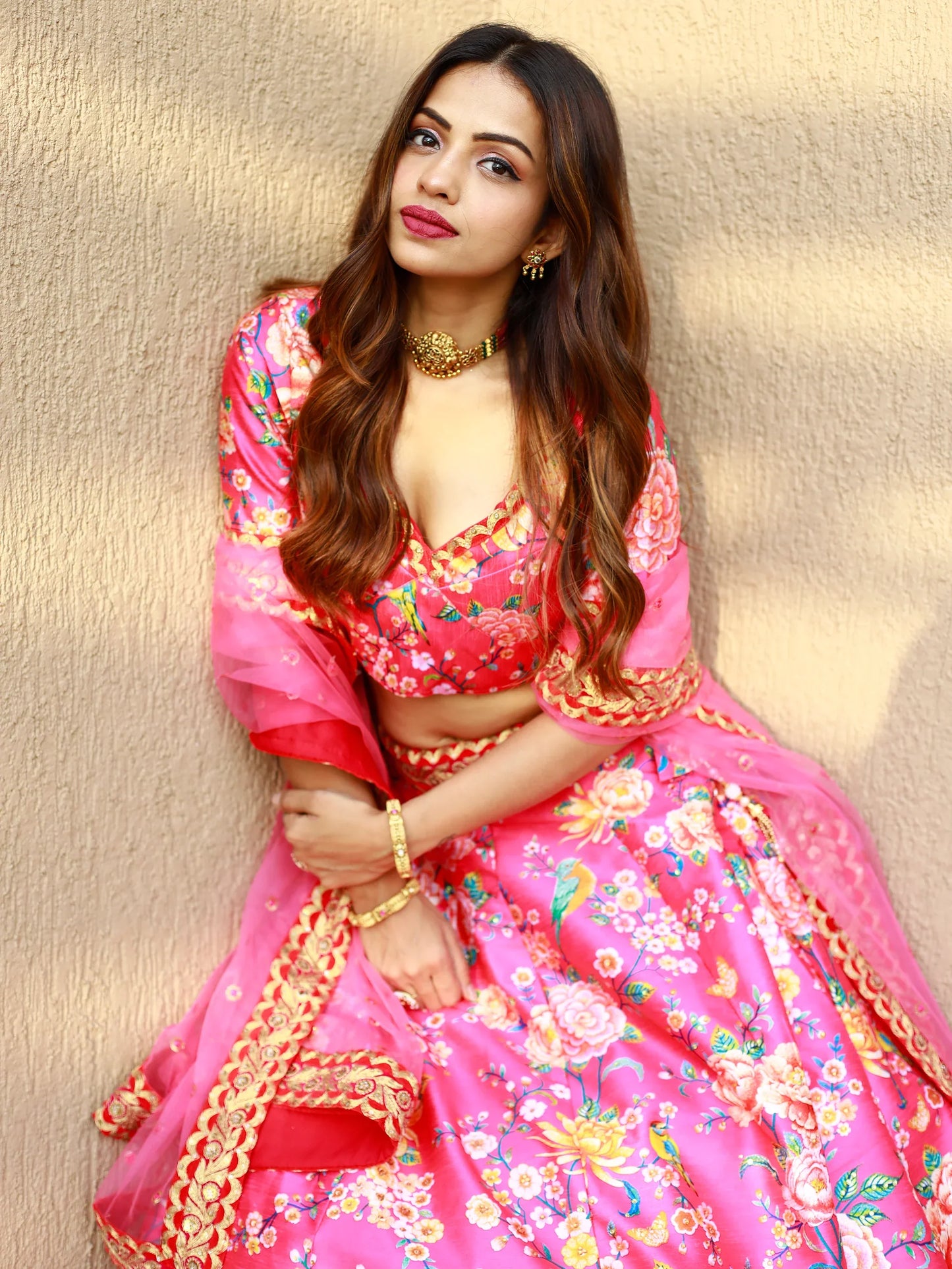 Pink floral print Indian designer lehenga for wedding shoot.