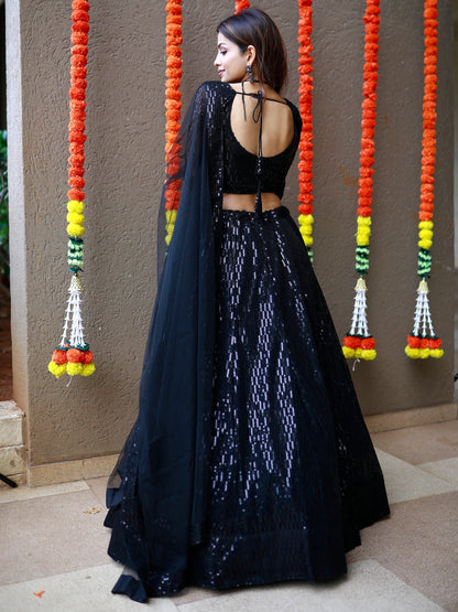 Black luxury bridal lehenga with net dupatta for wedding reception.