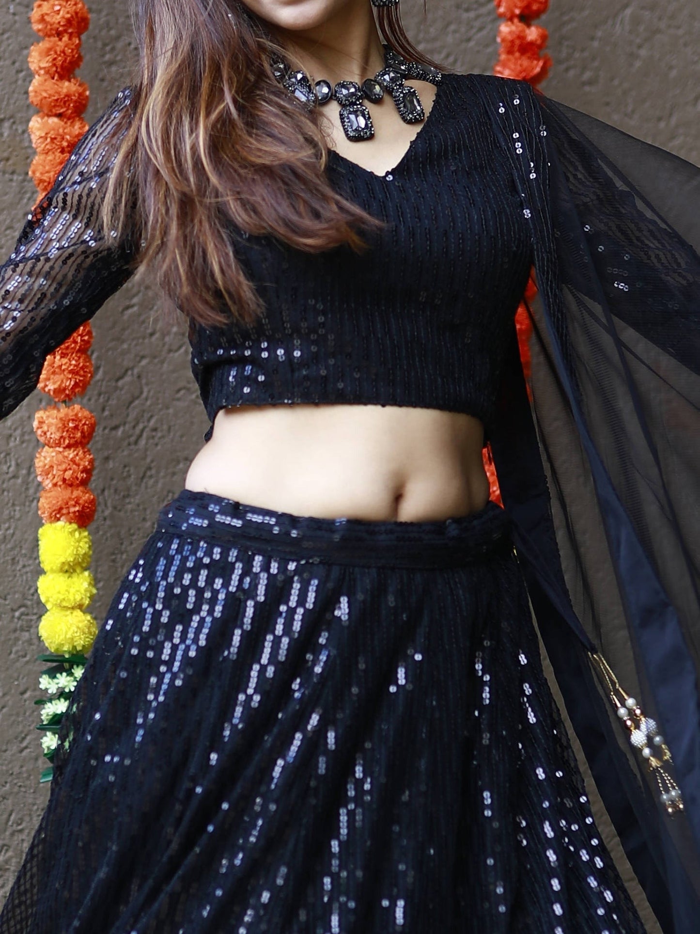 Black luxury bridal lehenga with net dupatta for wedding reception.