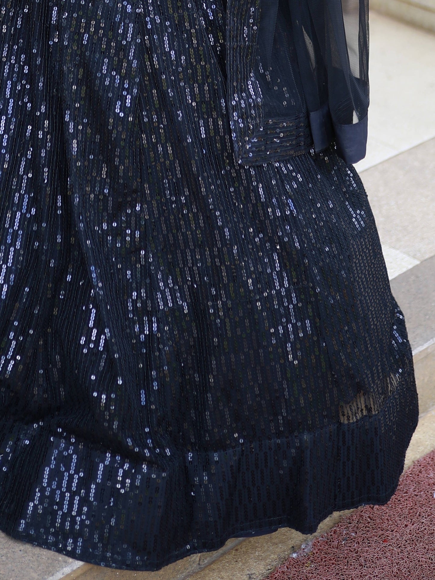 Black luxury bridal lehenga with net dupatta for wedding reception.