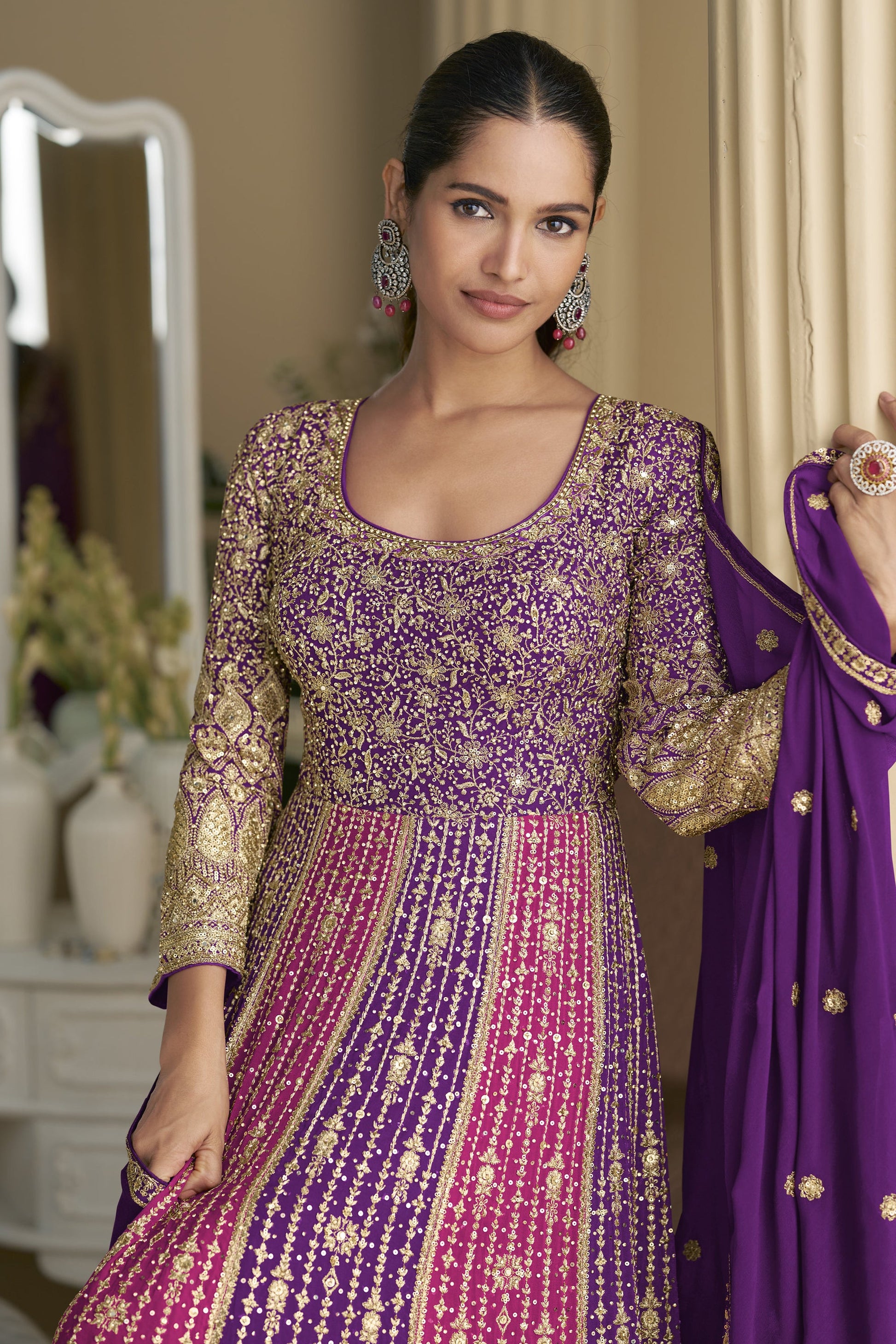 Woman wearing a traditional outfit with a purple dupatta 