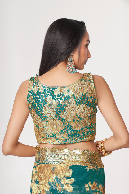 Teal blue organza saree with floral print—perfect for festivals.