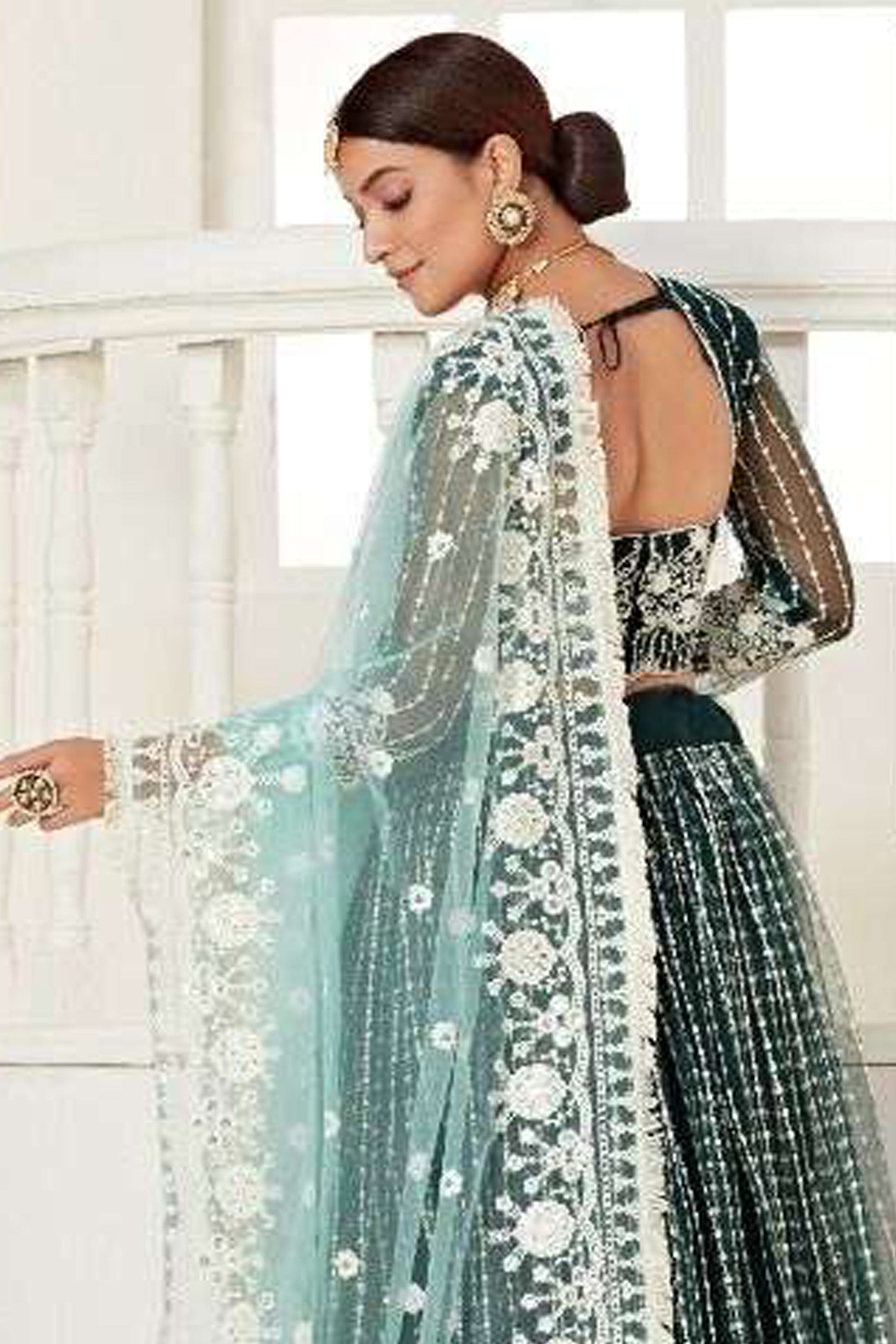 Close-Up Embroidery Detail On Green Bridal Lehenga Choli With Heavy Net Fabric