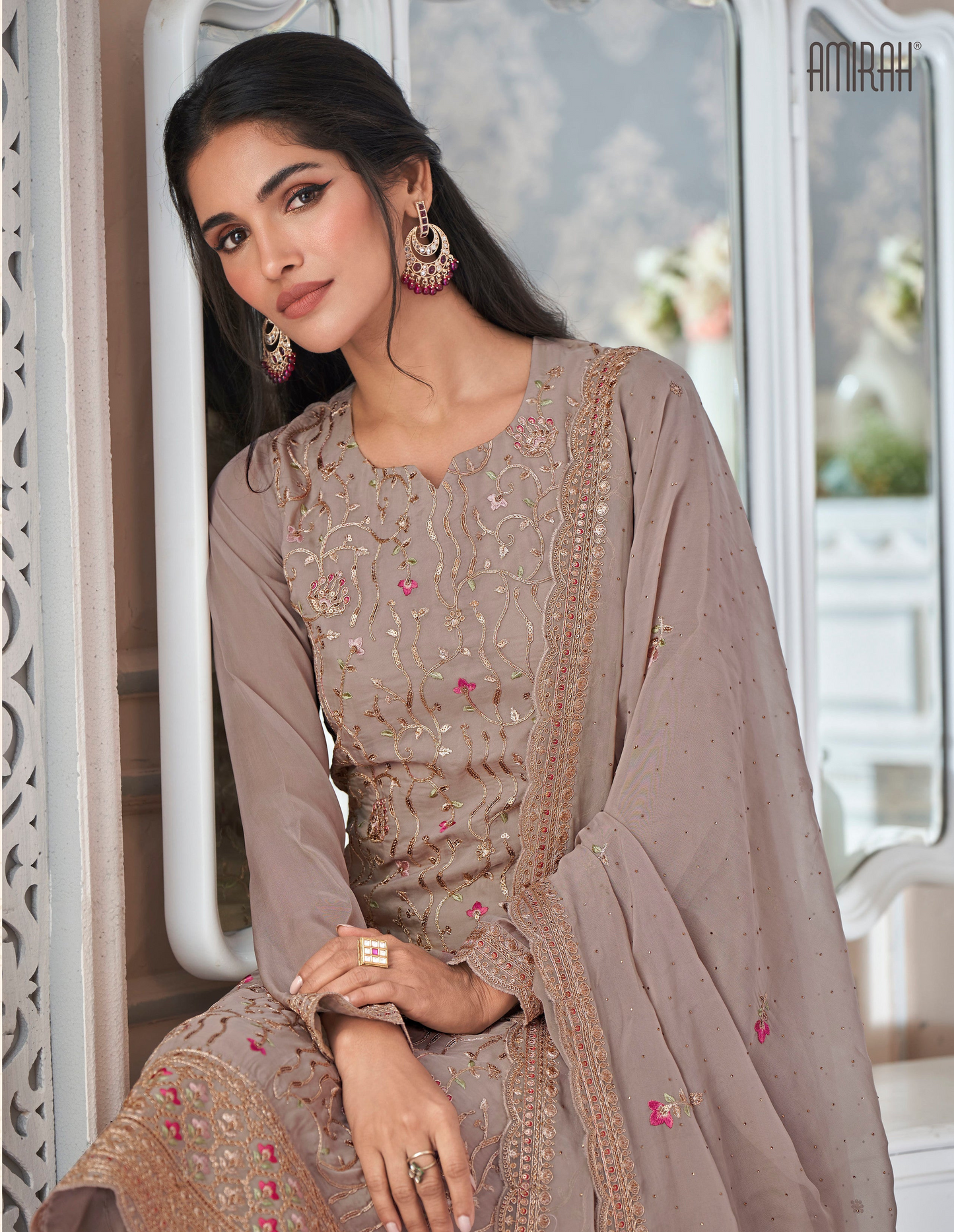 Close-up view of embroidery work on organza silk kameez