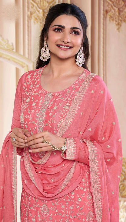 Close-up of embroidered chinon fabric on peach kameez