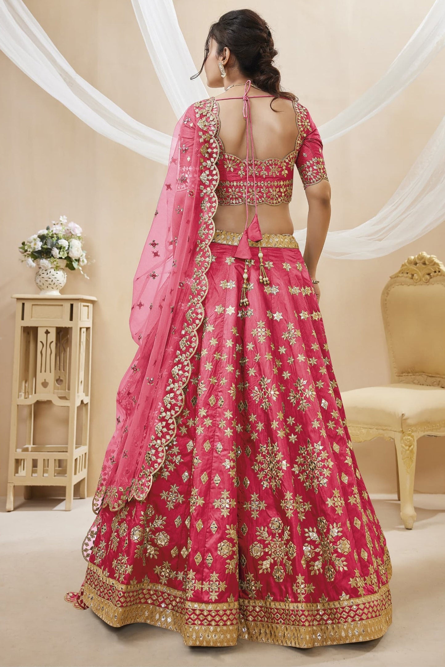 Pink bridal lehenga choli with embroidery for wedding reception.