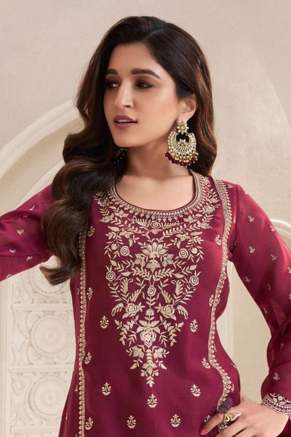 Close-up of embroidery detailing on red kameez