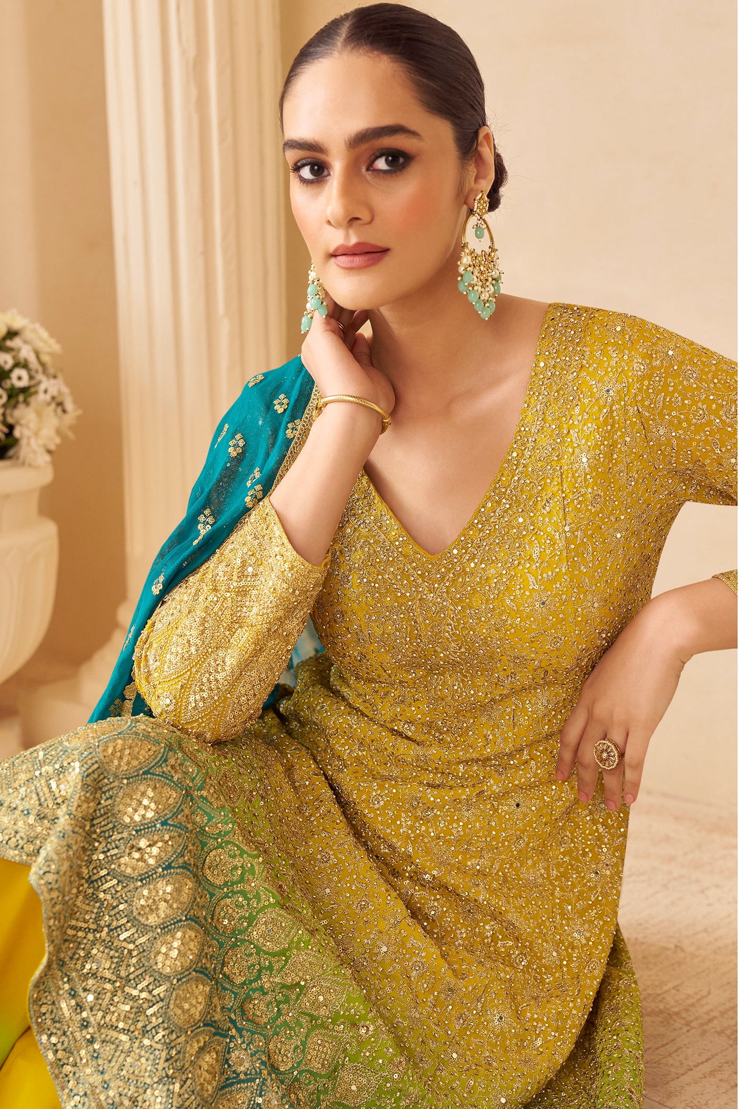 Woman in a yellow traditional outfit with a blue dupatta For USA And India