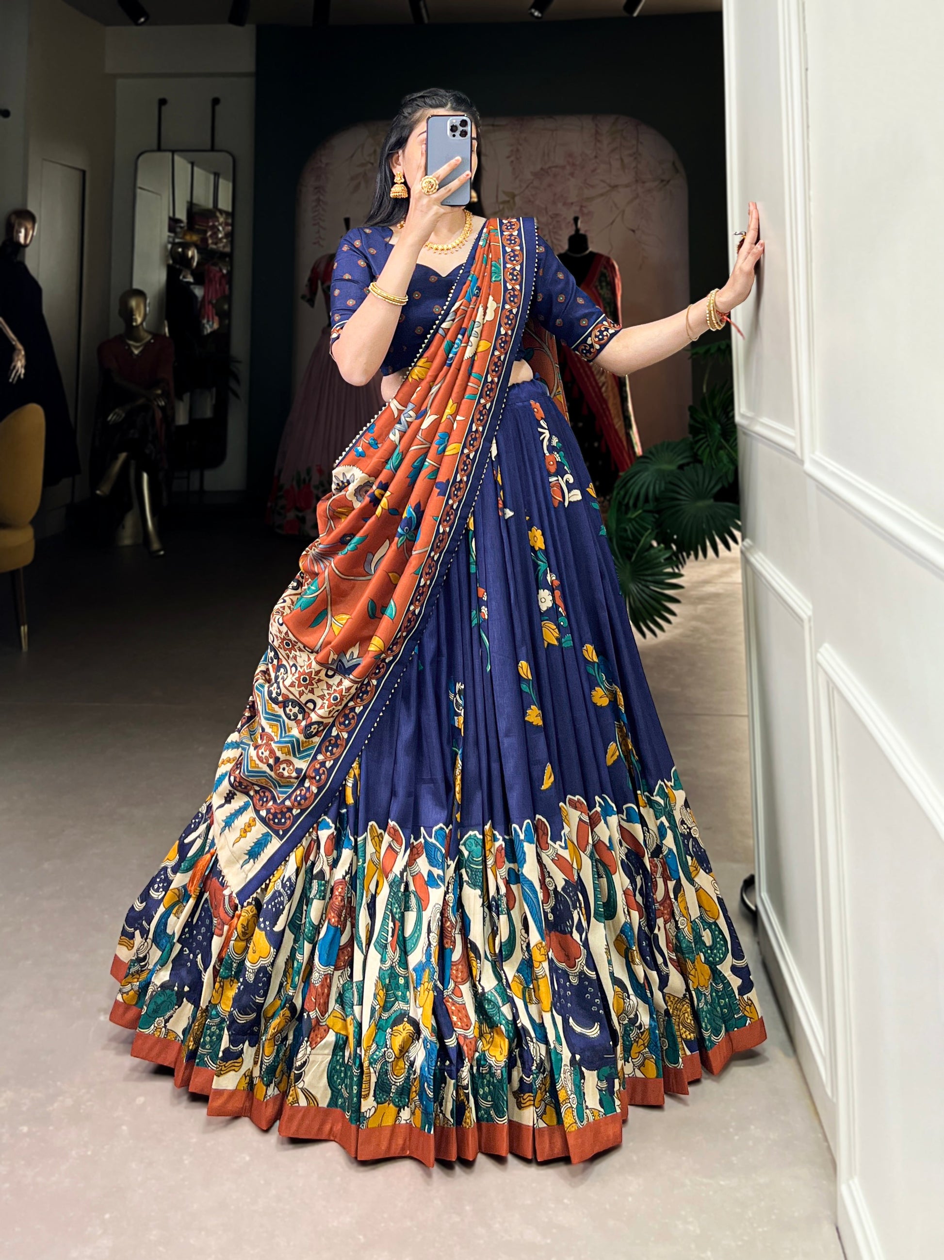 Navy blue Tussar silk lehenga with Kalamkari print work, blending traditional art with elegant festive style.
