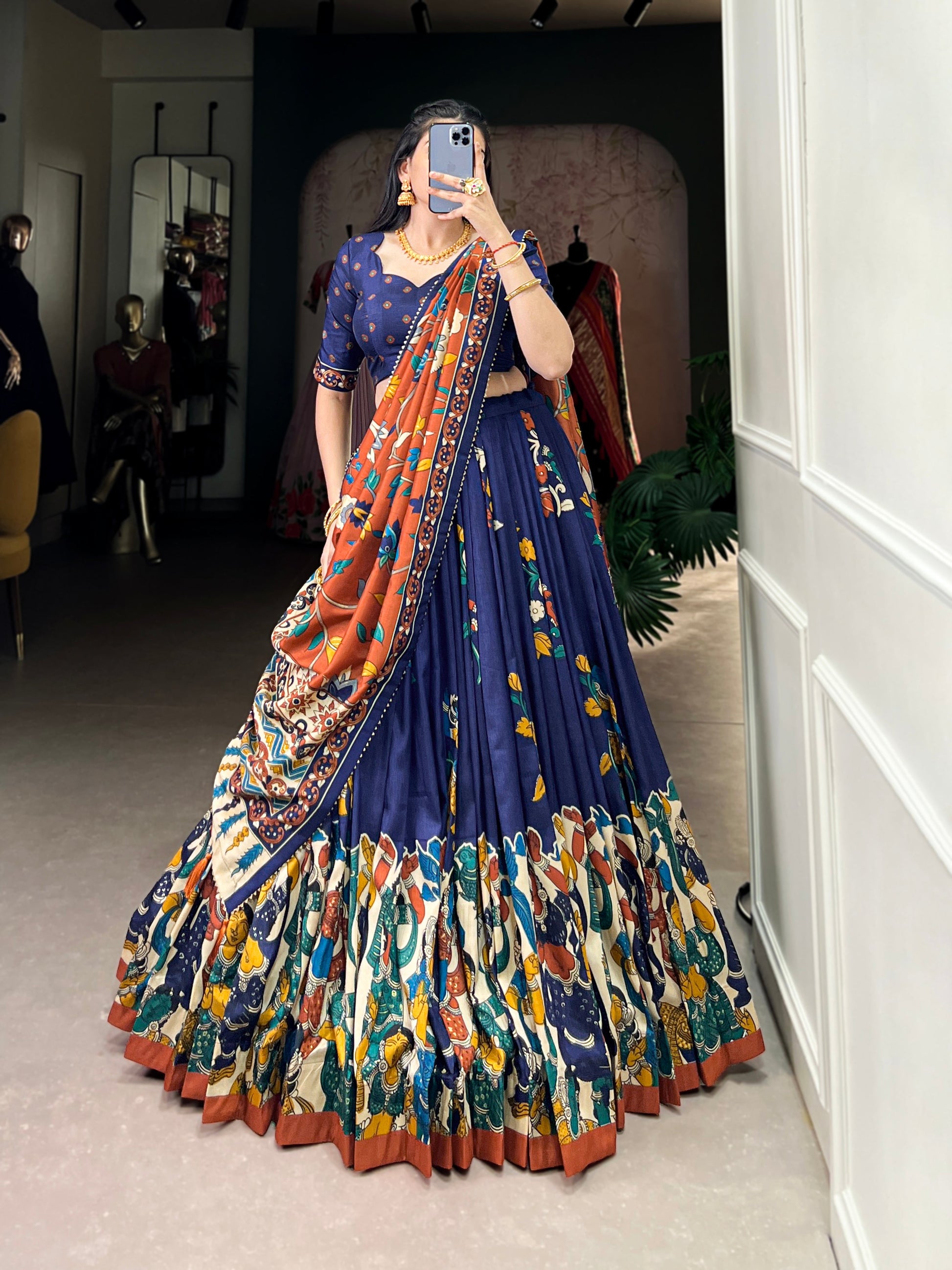 Navy blue Tussar silk lehenga with Kalamkari print work, blending traditional art with elegant festive style.
