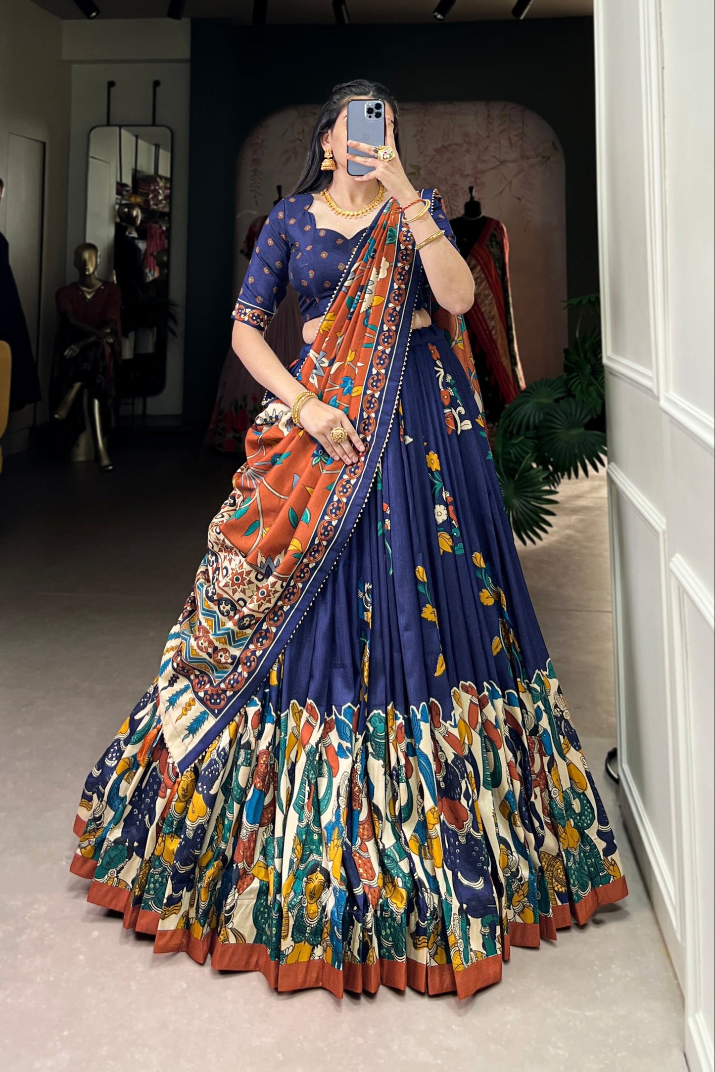 Navy blue Tussar silk lehenga with Kalamkari print work, blending traditional art with elegant festive style.
