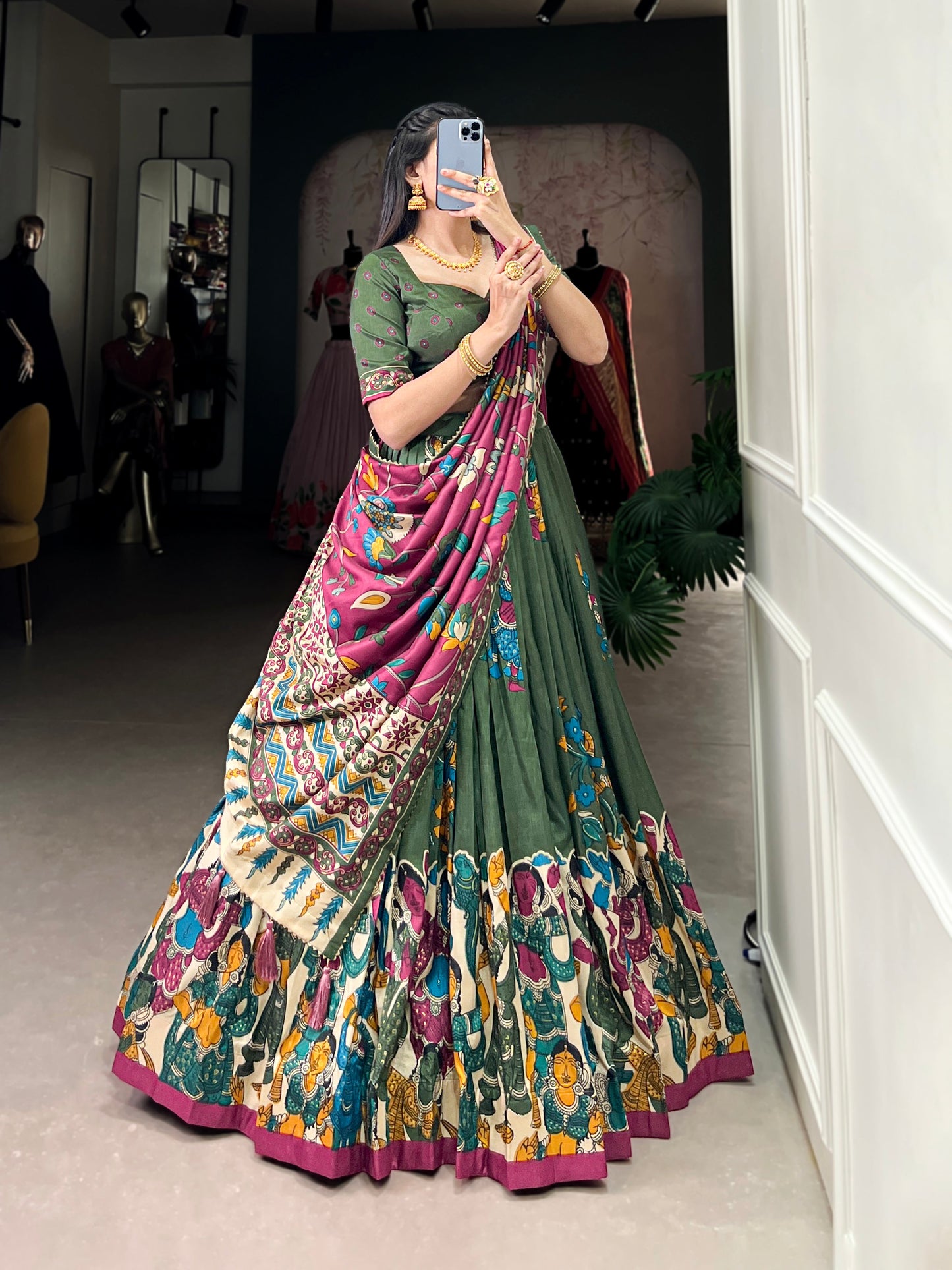 Dark green Tussar silk lehenga with Kalamkari print work, showcasing timeless traditional charm with a rich festive appeal.
