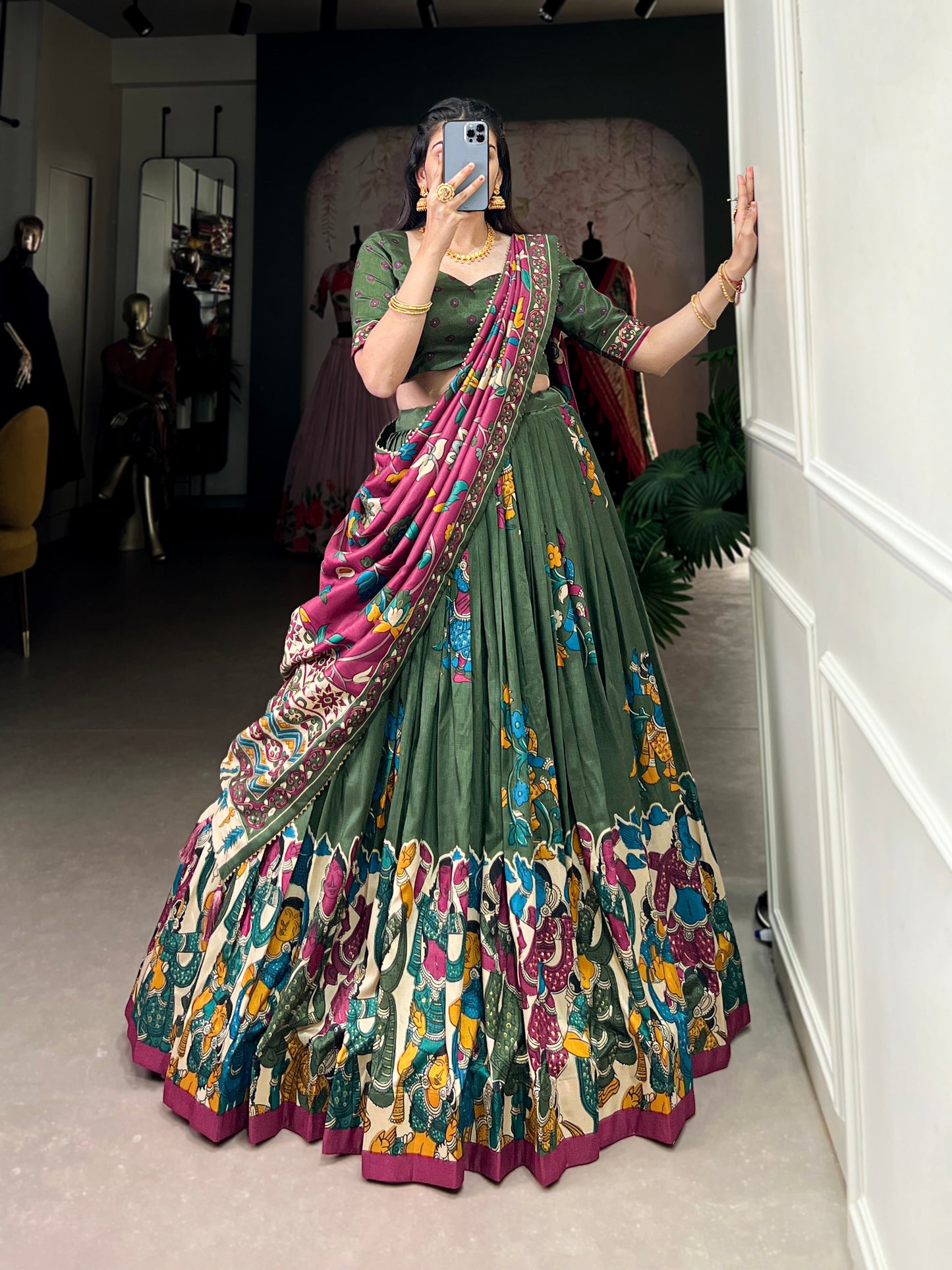 Dark green Tussar silk lehenga with Kalamkari print work, showcasing timeless traditional charm with a rich festive appeal.
