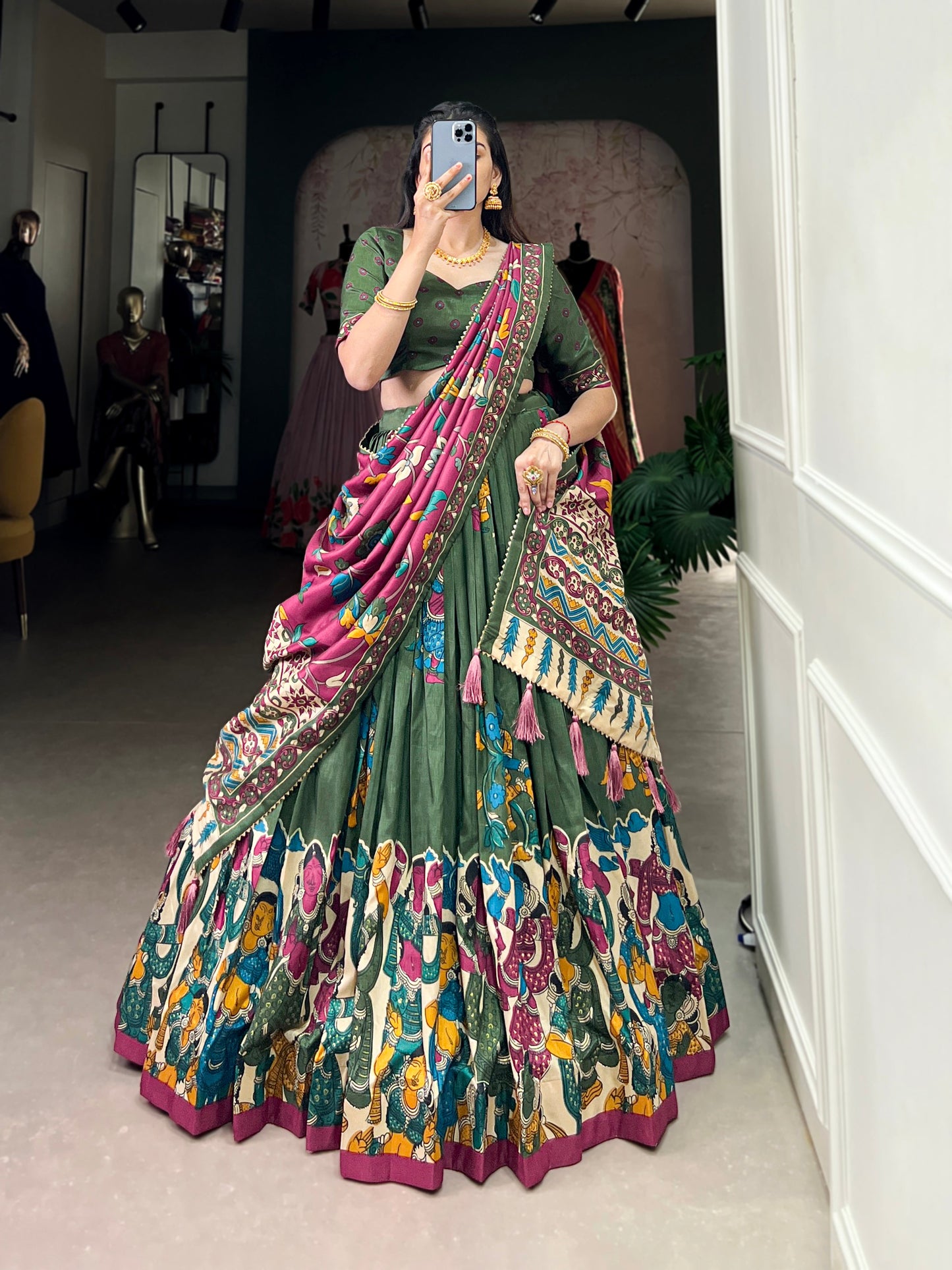 Dark green Tussar silk lehenga with Kalamkari print work, showcasing timeless traditional charm with a rich festive appeal.
