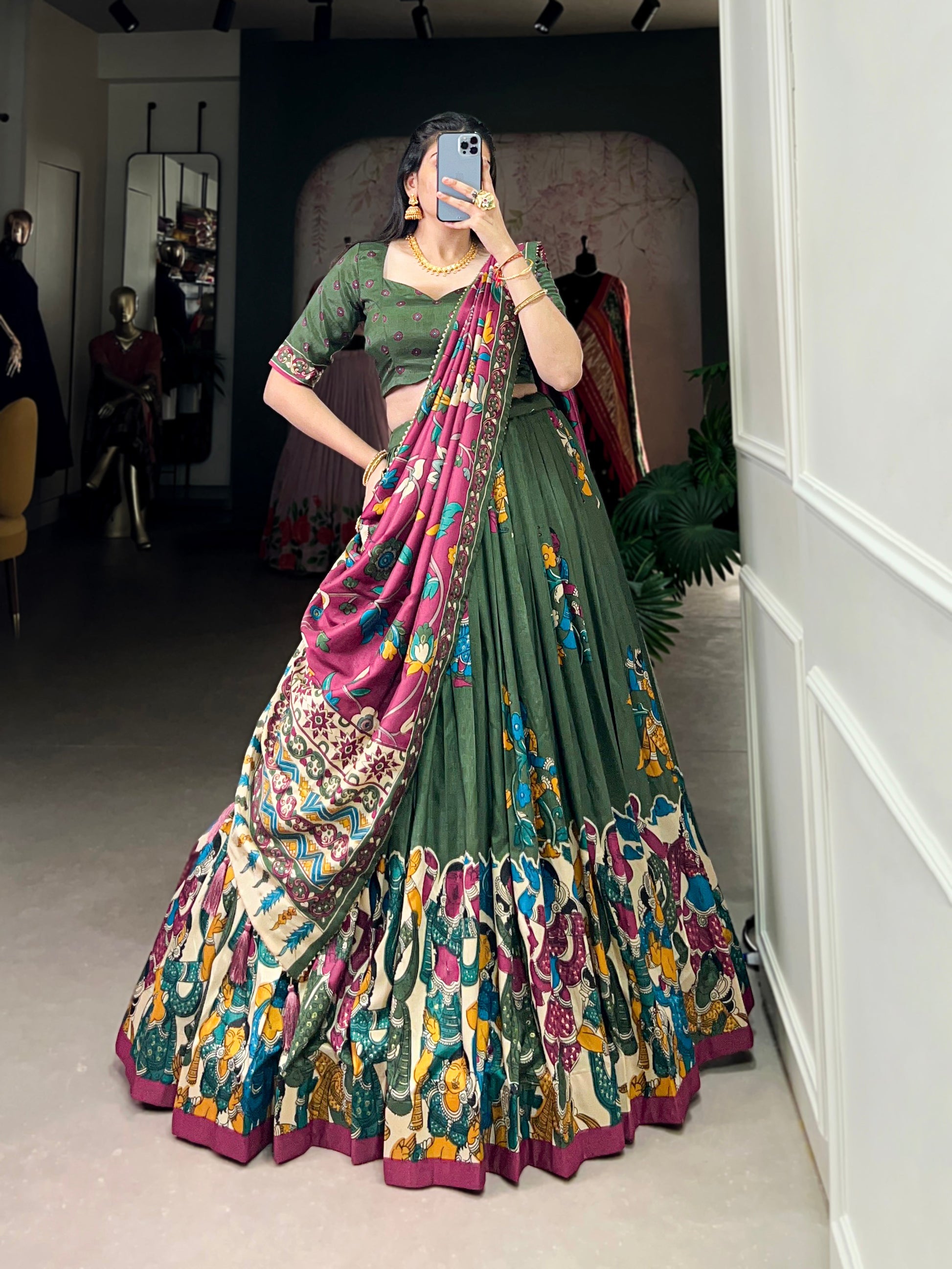 Dark green Tussar silk lehenga with Kalamkari print work, showcasing timeless traditional charm with a rich festive appeal.

