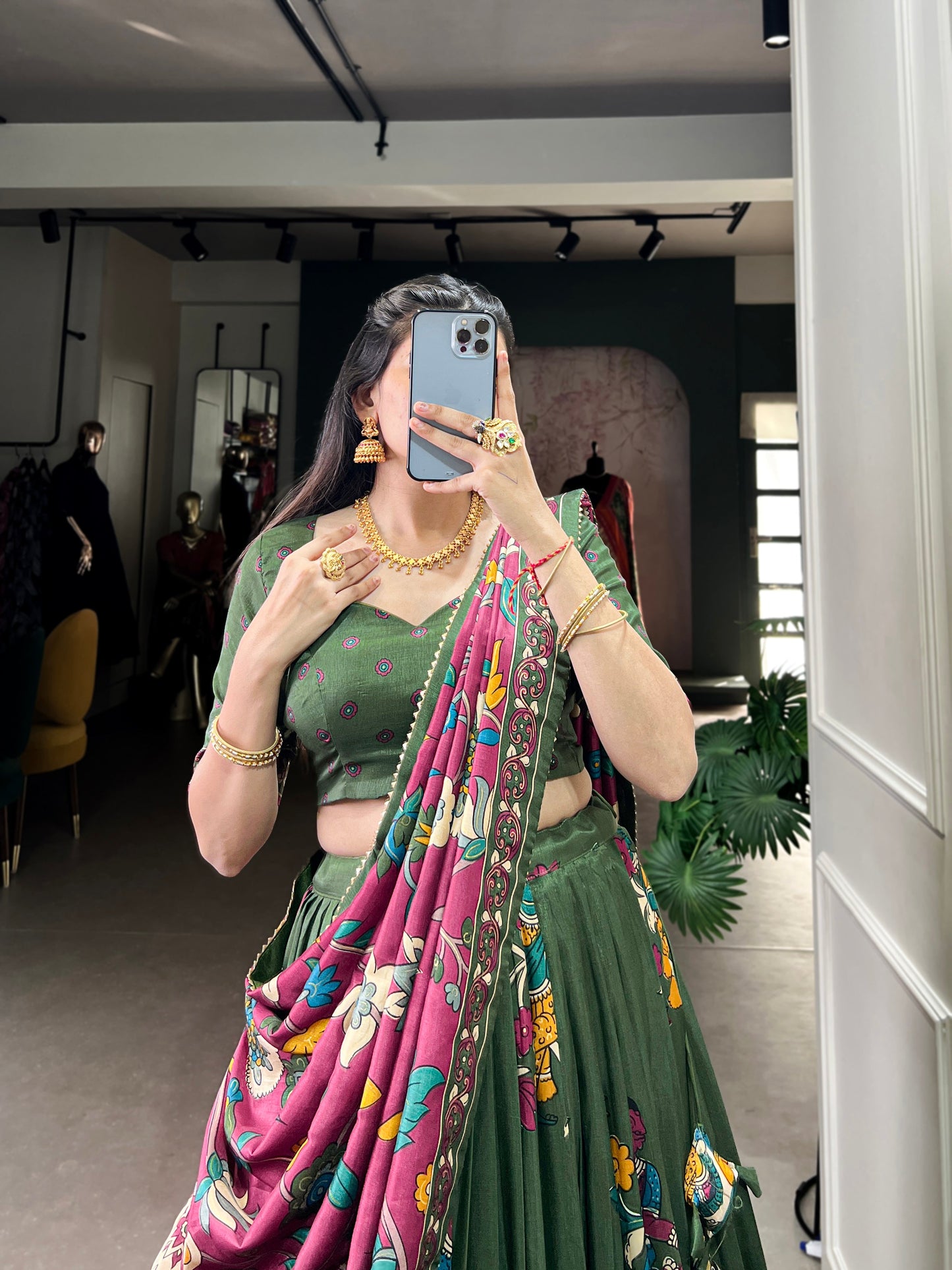 Dark green Tussar silk lehenga with Kalamkari print work, showcasing timeless traditional charm with a rich festive appeal.
