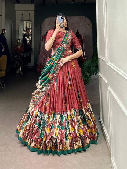 Red Tussar silk lehenga with Kalamkari print work, adorned with vibrant traditional motifs for a bold and festive look.
