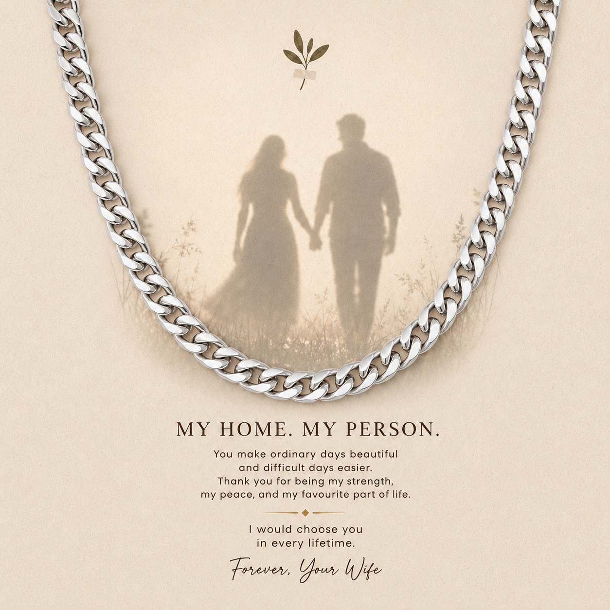 A silver curb chain necklace draped over a beige memorial-style card with a faded silhouette of a couple holding hands and the text 'MY HOME. MY PERSON.