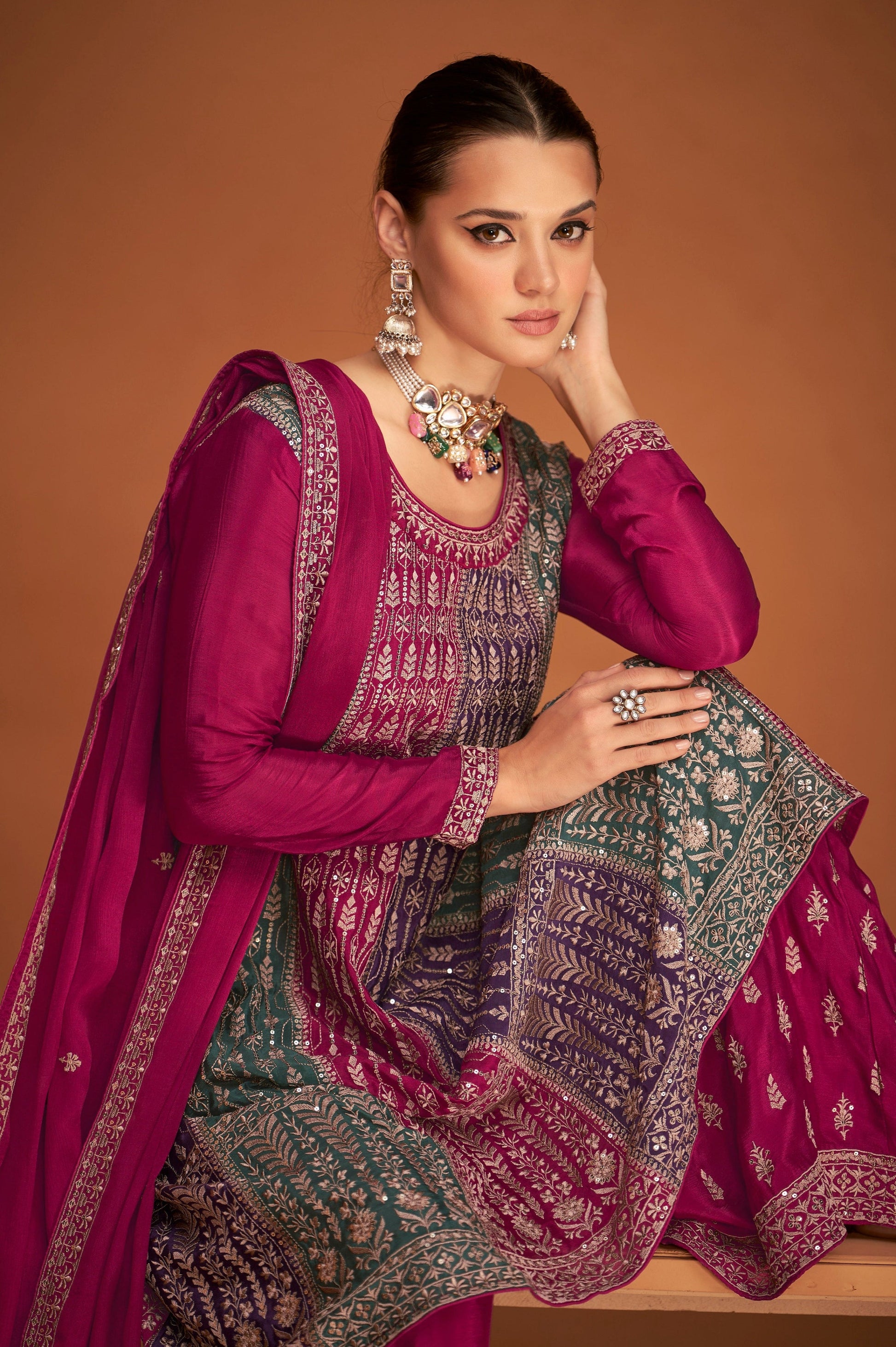 A Woman Modeling a Traditional Indian Salwar Kameez Dupatta Dress in Pink and Pink with Intricate Thread  Embroidery Worked.