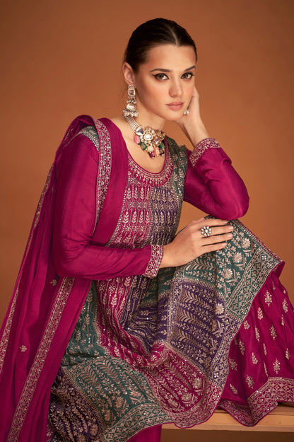A Woman Modeling a Traditional Indian Salwar Kameez Dupatta Dress in Pink and Pink with Intricate Thread  Embroidery Worked.