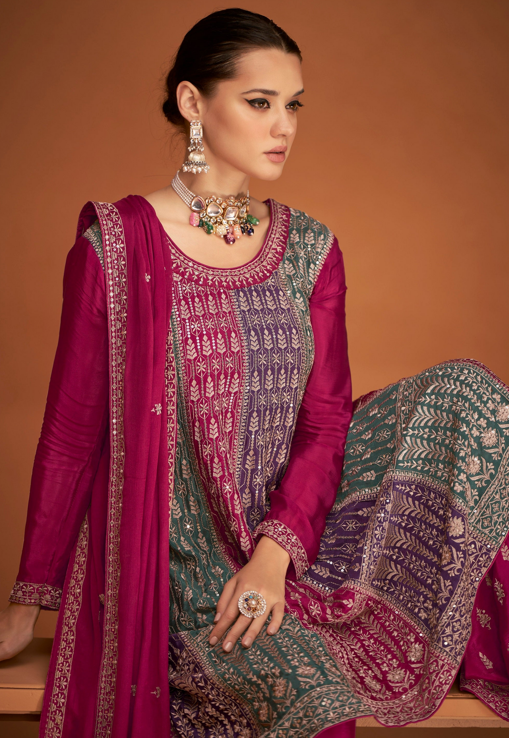 A Woman Modeling a Traditional Indian Salwar Kameez Dupatta Dress in Pink and Pink with Intricate Thread  Embroidery Worked.