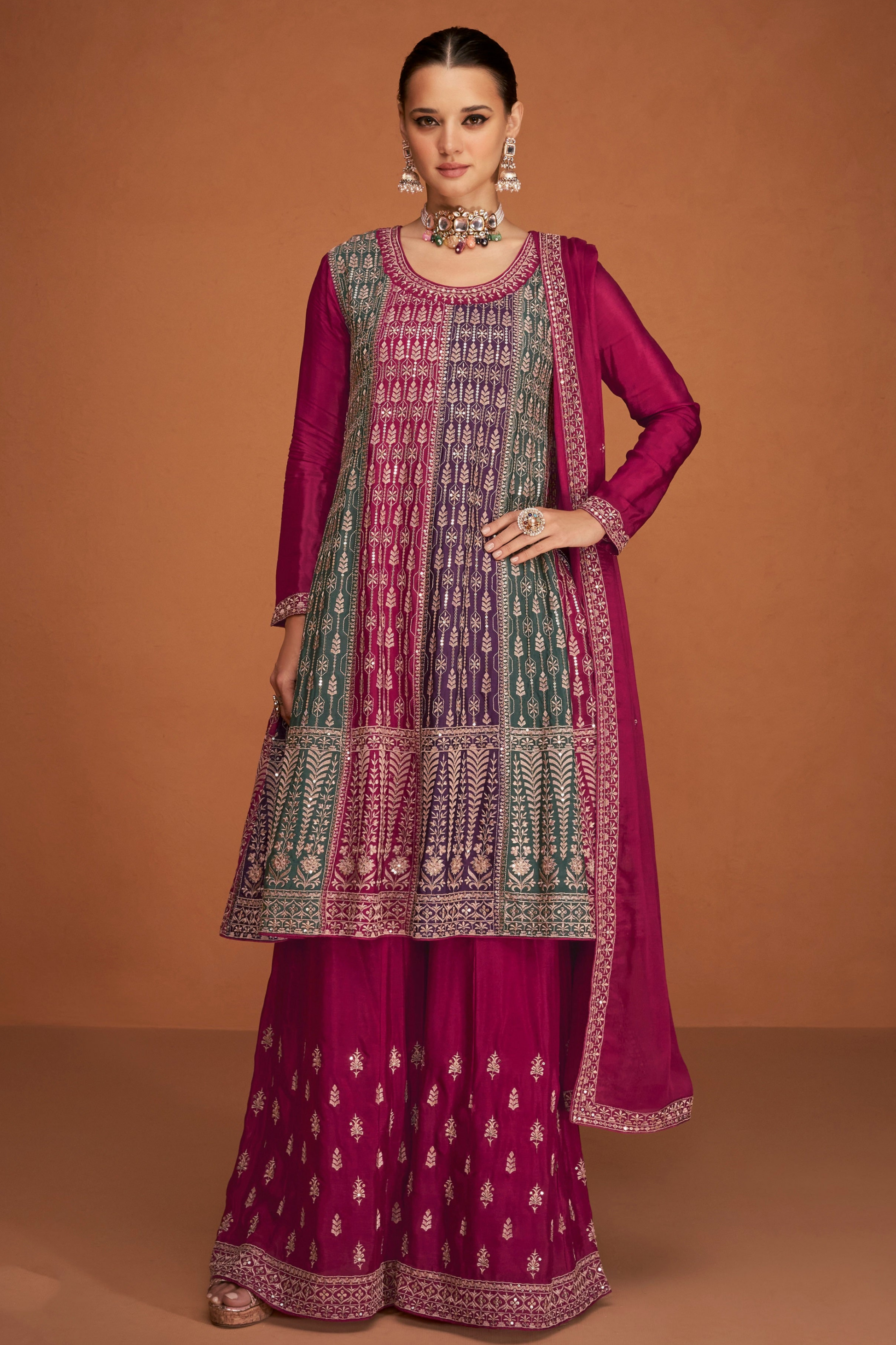 A Woman Modeling a Traditional Indian Salwar Kameez Dupatta Dress in Pink and Pink with Intricate Thread  Embroidery Worked.