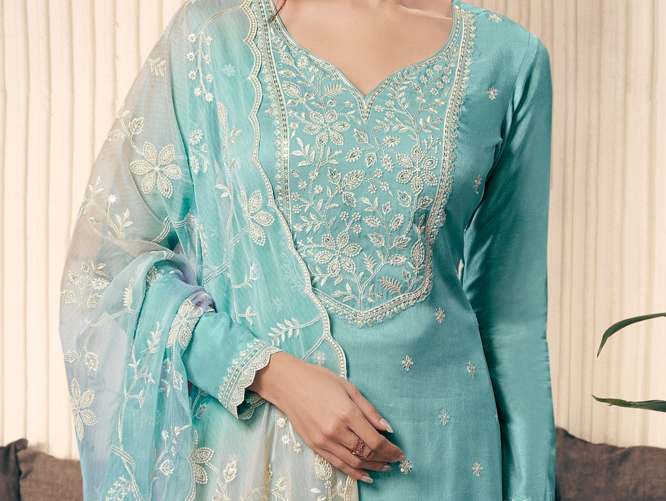 close-up of thread embroidery work on sky blue kurta