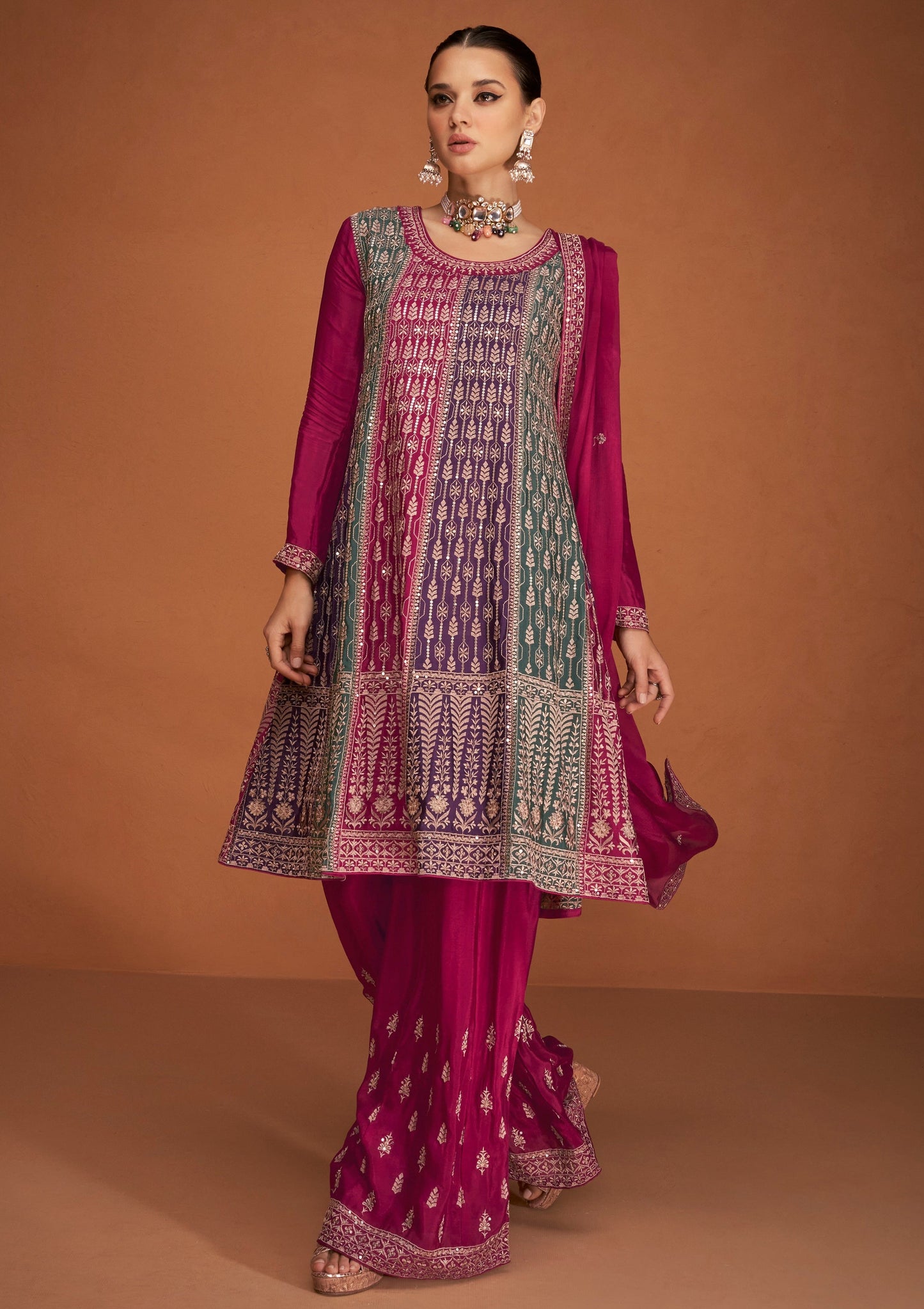 A Woman Modeling a Traditional Indian Salwar Kameez Dupatta Dress in Pink and Pink with Intricate Thread  Embroidery Worked.