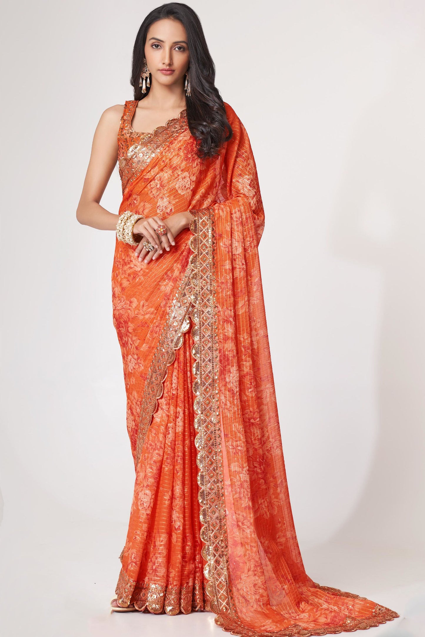 Orange Saree radiates warmth and vibrance – perfect for traditional functions and cultural flair. 