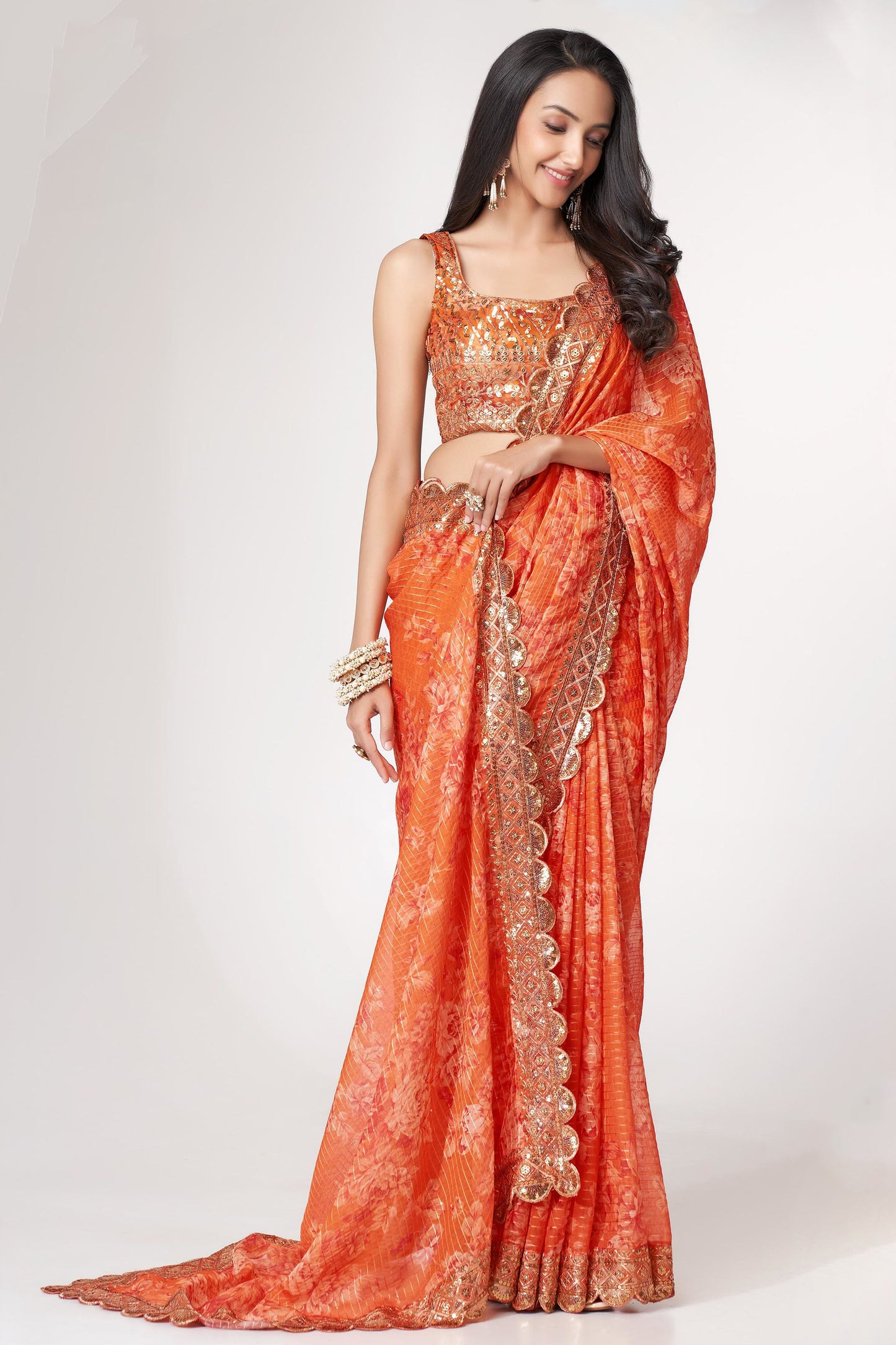 Orange Saree radiates warmth and vibrance – perfect for traditional functions and cultural flair. 