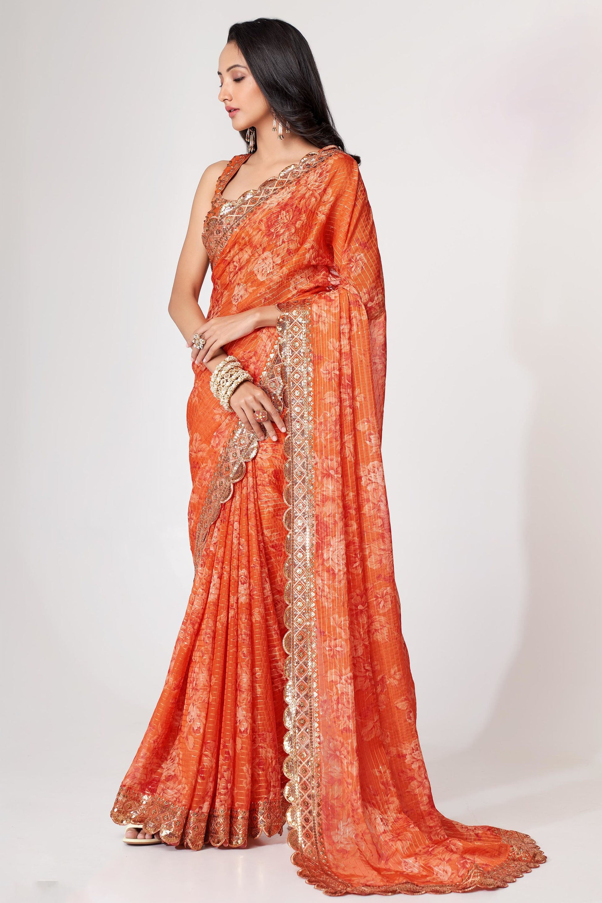 Orange Saree radiates warmth and vibrance – perfect for traditional functions and cultural flair. 