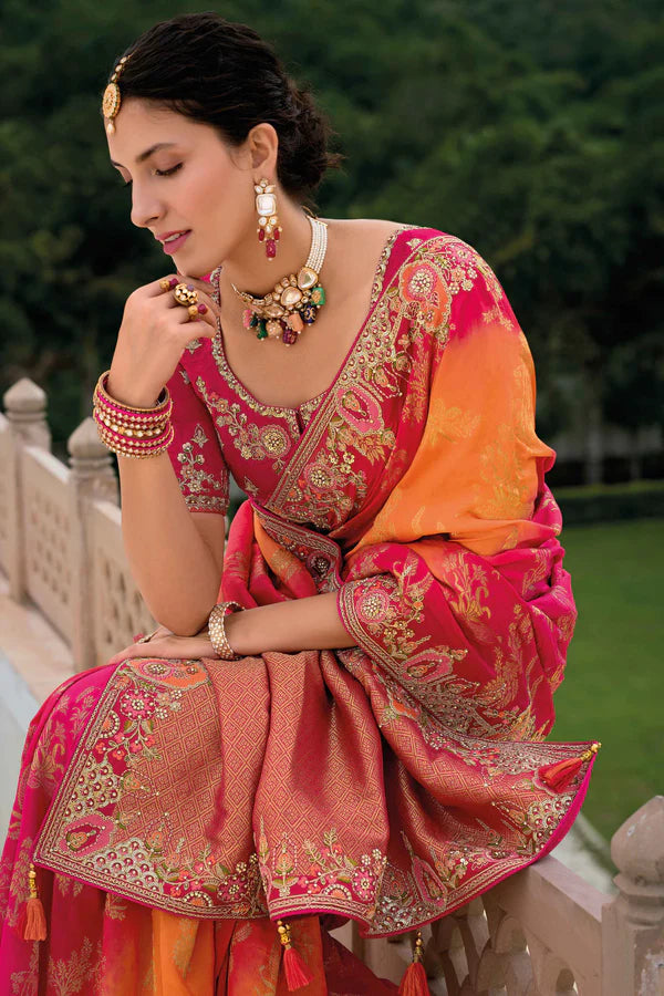 Radiant pink-orange saree with fully embroidered pink blouse.