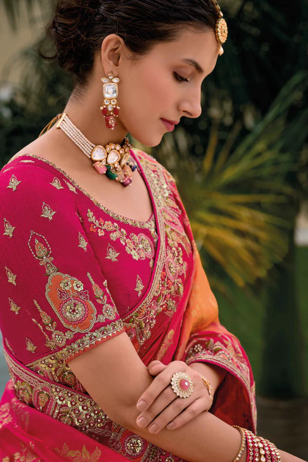 Radiant pink-orange saree with fully embroidered pink blouse.