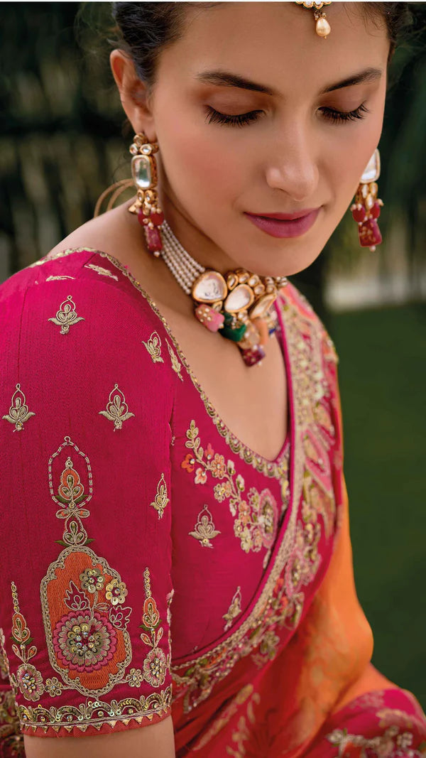 Radiant pink-orange saree with fully embroidered pink blouse.