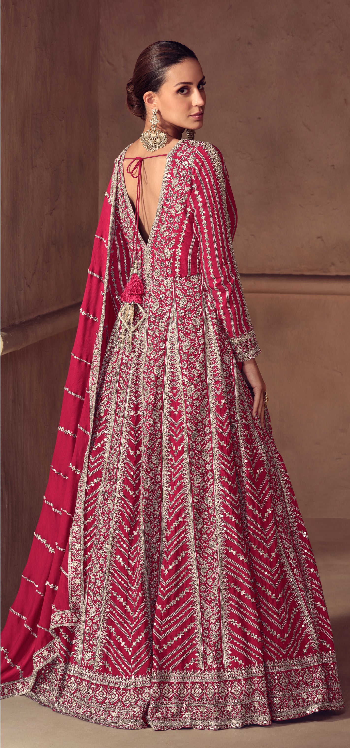 Woman wearing a Magenta Pink patterned traditional outfit with a matching dupatta For Wedding and Festival
