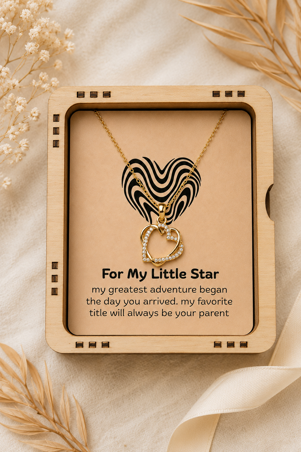 Double heart silver-tone pendant necklace displayed inside illuminated wooden box