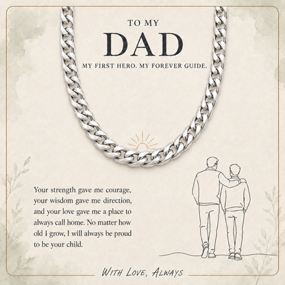 A silver curb-link chain necklace displayed on a beige printed card with sentimental text and a small line drawing of two people standing together. The card reads, 'TO MY DAD MY FIRST HERO.