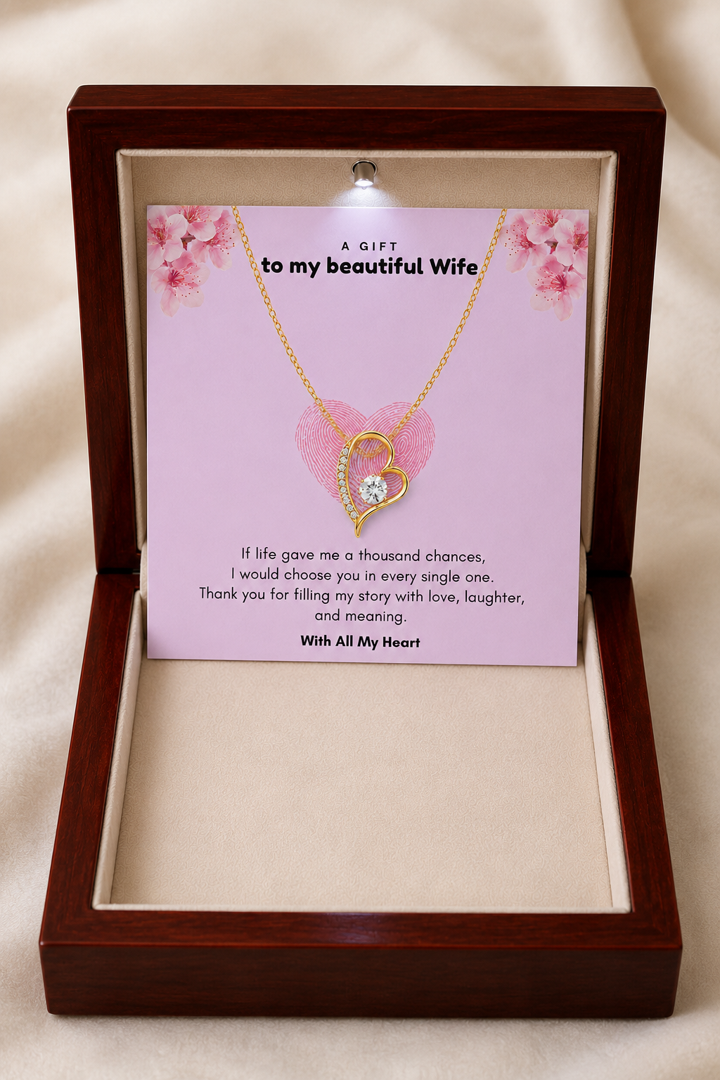 Open-heart pendant necklace with crystal-style accents presented on a decorative message card.