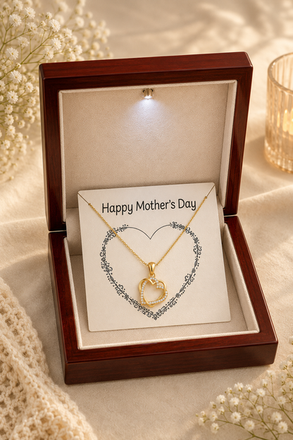 Gold-tone heart pendant necklace arranged over decorative heart illustration on message card