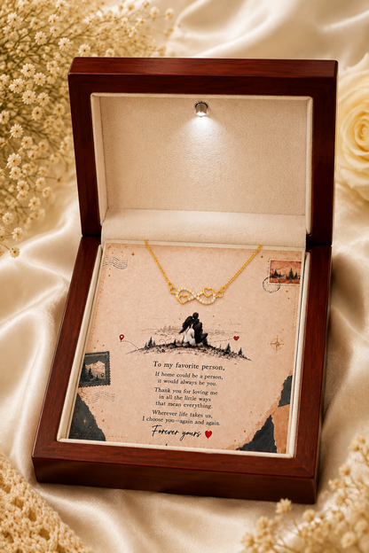 Gold-tone infinity heart necklace displayed above romantic couple message card