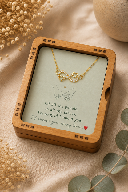 Gold-tone infinity heart necklace presented inside an open jewelry gift box