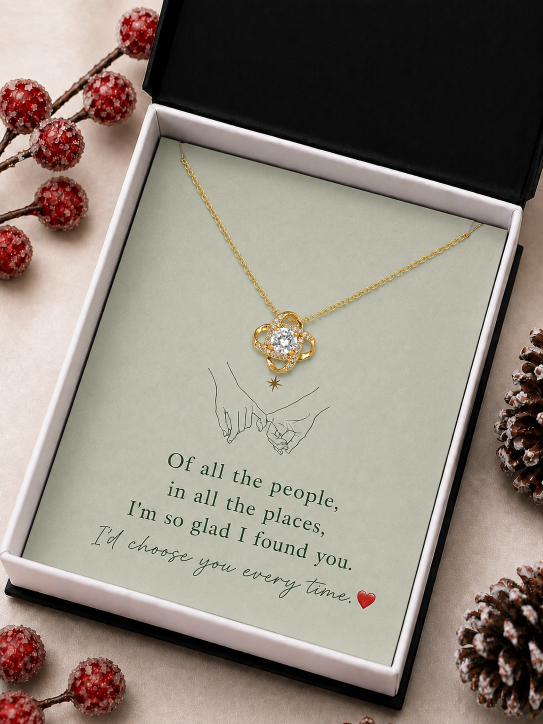 Gold-tone interlocking pendant necklace and romantic message card photographed in luxury gift styling