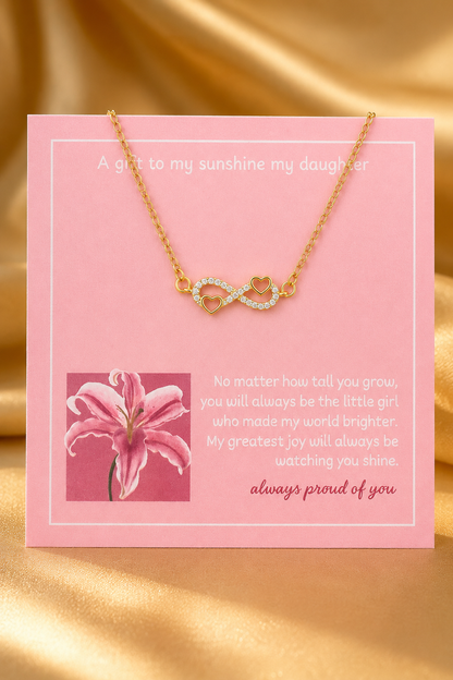 Gold-tone infinity heart necklace displayed with sentimental daughter message card