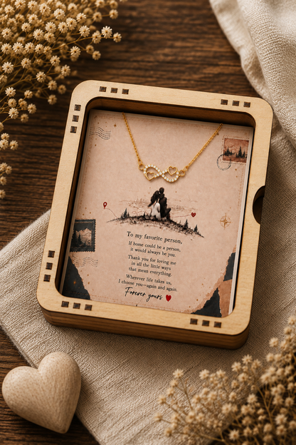 Gold-tone infinity pendant necklace featuring heart details and clear accents