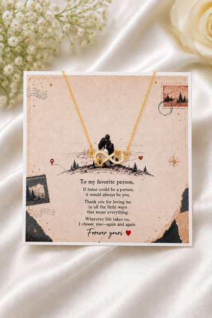Gold-tone infinity heart necklace with clear accents and heartfelt message card