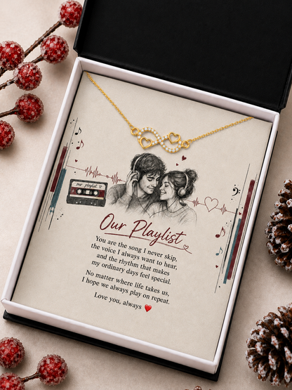 Gold-tone infinity heart necklace displayed in wooden box with romantic message