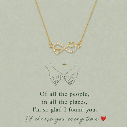 Gold-tone infinity heart necklace with two open-heart details and clear accents