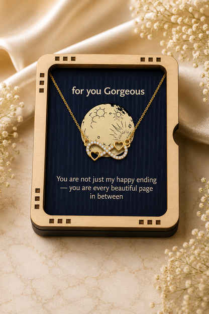 Gold-tone infinity pendant necklace presented in a black gift box