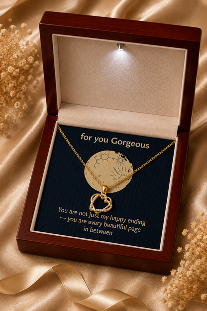 Gold-tone pendant necklace arranged on a dark message card inside a LED wooden presentation box