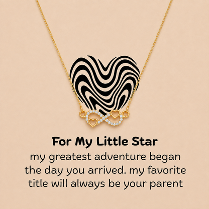 Gold-tone heart infinity necklace with message card expressing a parent’s love for their little star